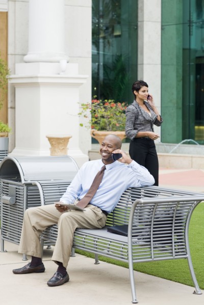 Business people talking on cell phones outdoors