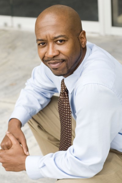 Black businessman sitting outdoors