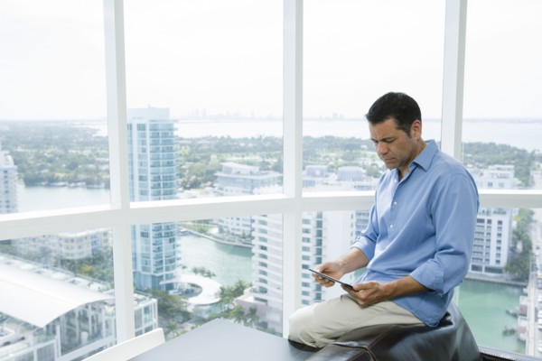 Hispanic businessman using digital tablet in office