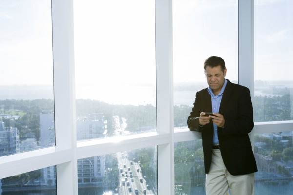 Hispanic businessman using cell phone