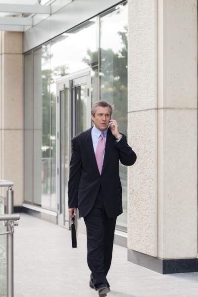 Caucasian businessman on cell phone outdoors