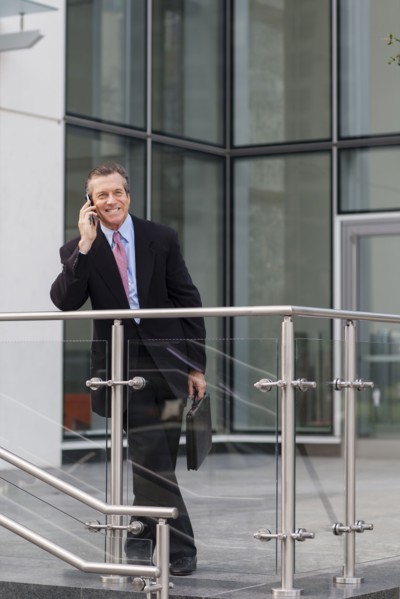 Caucasian businessman on cell phone outside building