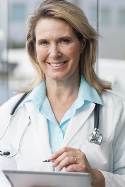 Close up of Caucasian doctor using digital tablet