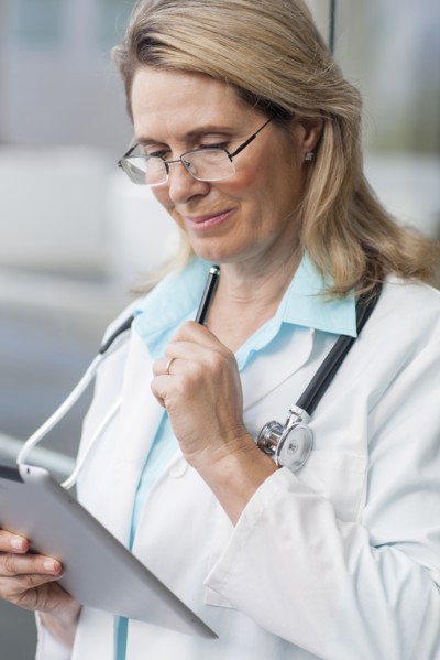 Close up of Caucasian doctor using digital tablet