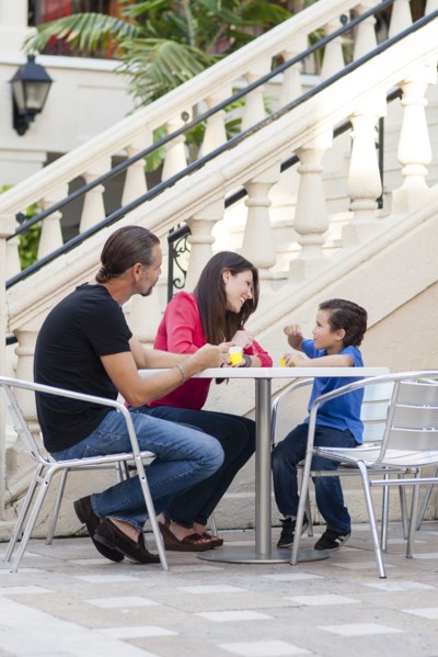 Caucasian family eating at sidewalk cafe