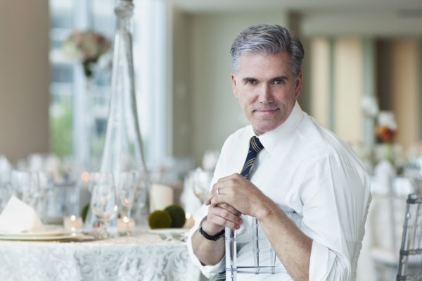 Caucasian businessman smiling in empty dining room
