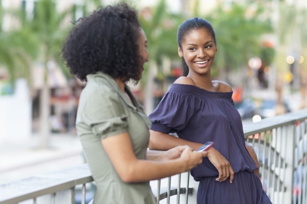 Black women talking on balcony