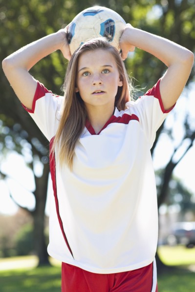 Caucasian soccer player throwing ball