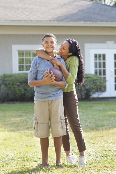 Mother and son hugging in backyard