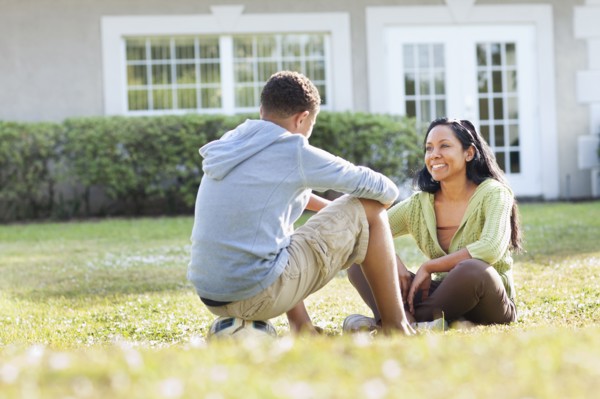 Mother and son talking in backyard