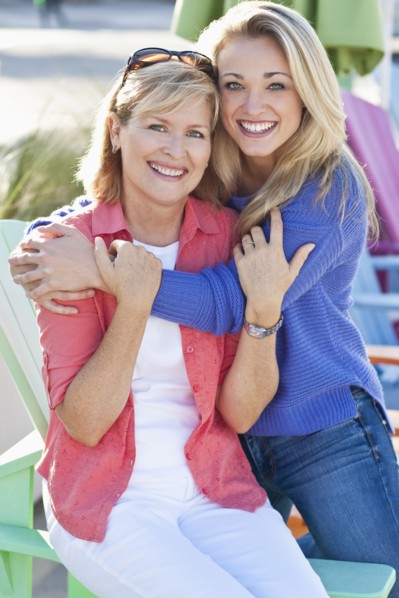 Caucasian mother and daughter hugging outdoors