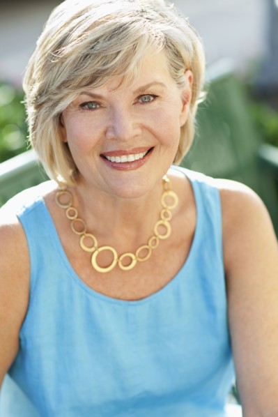 Smiling Caucasian woman sitting on park bench