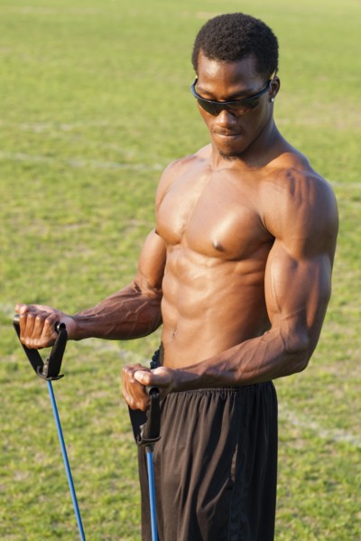 Black athlete working out on sports field
