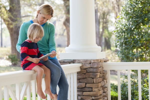 Caucasian mother and son talking on patio