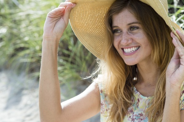 Caucasian woman wearing sun hat on beach