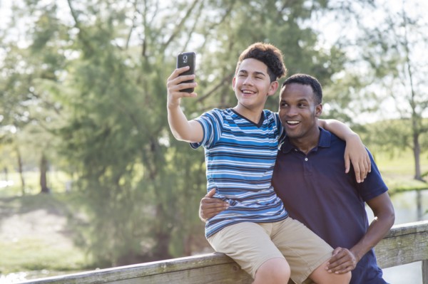 Father and son taking selfie outdoors