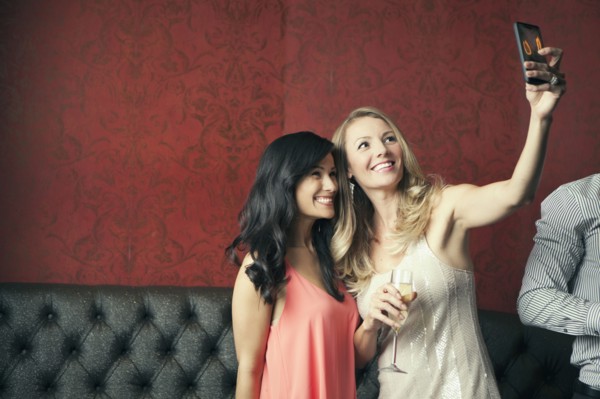 Women taking picture together in nightclub