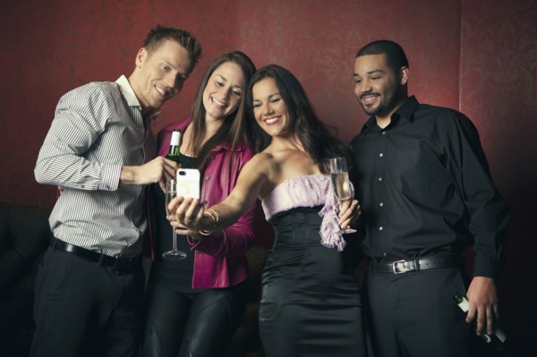 Friends taking picture together in nightclub