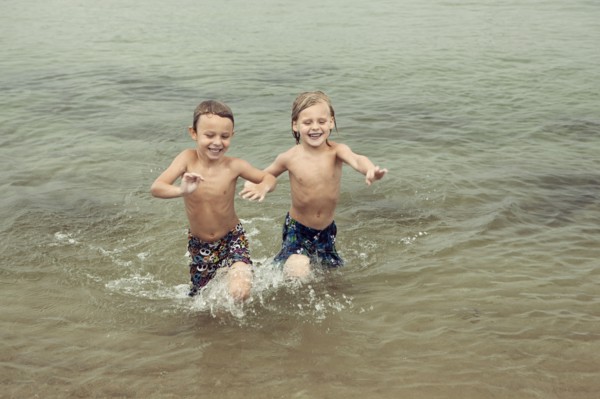 Caucasian boys playing in lake