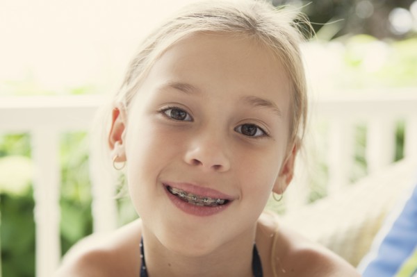 Caucasian girl smiling with braces