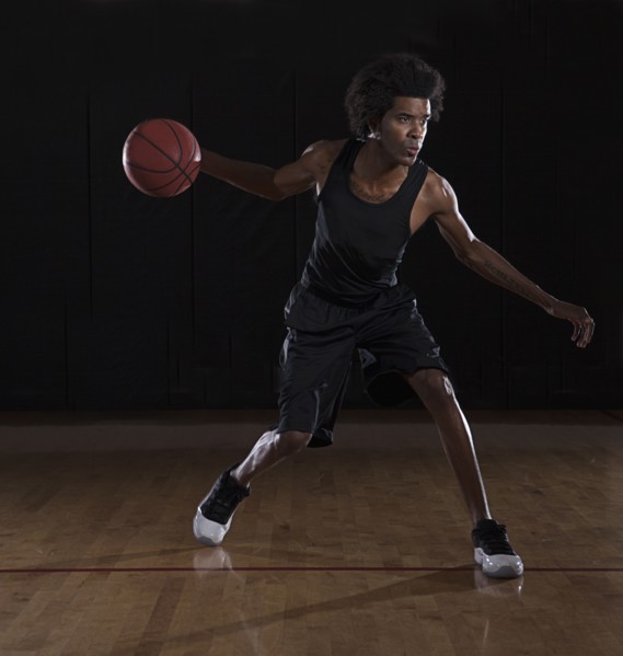 African American man playing basketball on court
