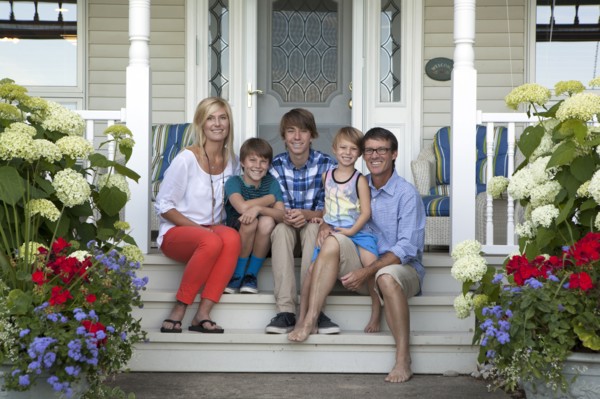 Caucasian family smiling on front porch