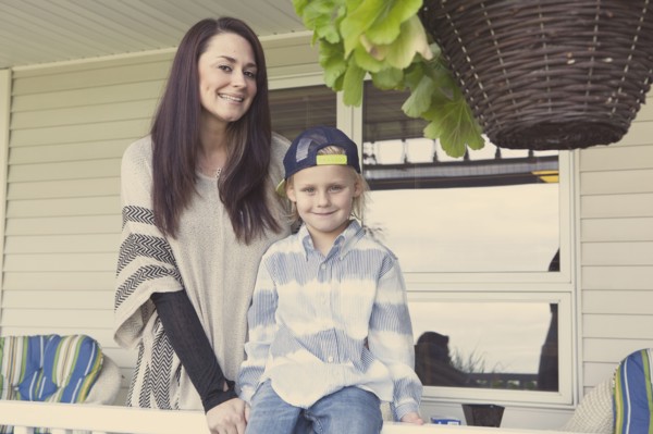 Caucasian mother and son smiling on porch