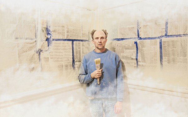 Caucasian man painting himself into corner