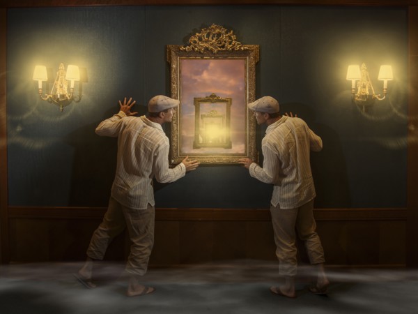 Caucasian twins peering into mirror