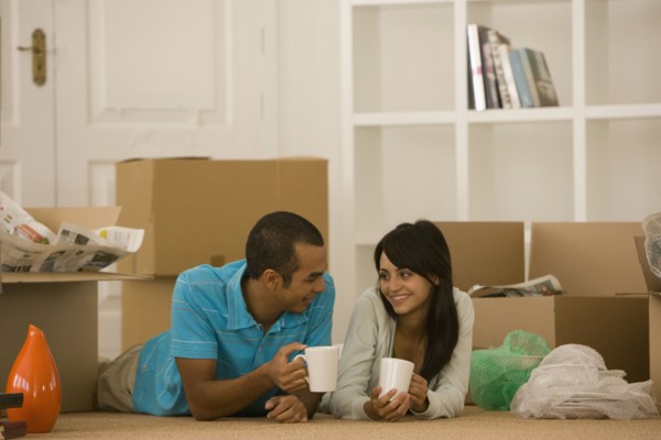 Young couple next to unpacked moving boxes