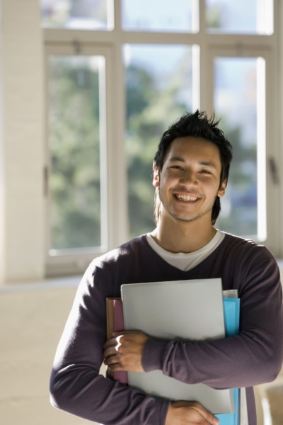Asian man holding binders