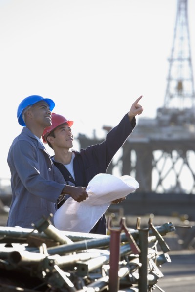 Multi-ethnic male construction workers pointing