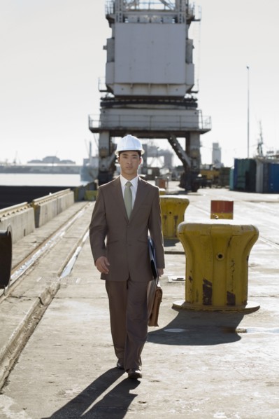 Asian businessman walking on commercial pier