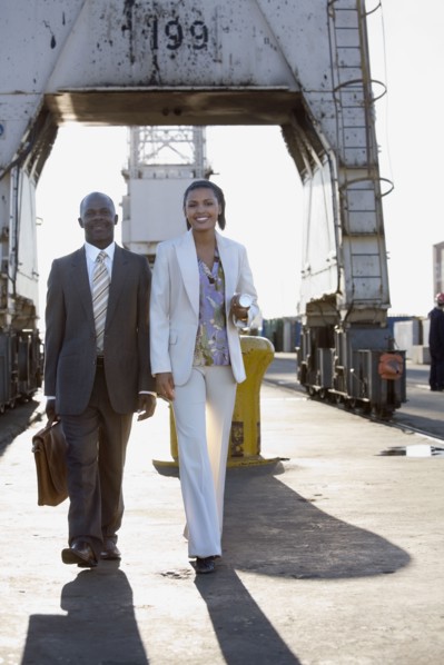 African American businesspeople walking on commercial pier