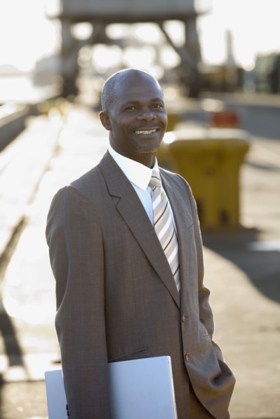 African American businessman holding laptop
