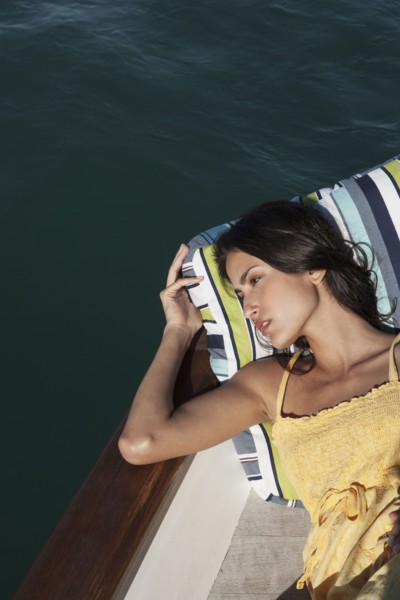 Caucasian woman relaxing on sailboat
