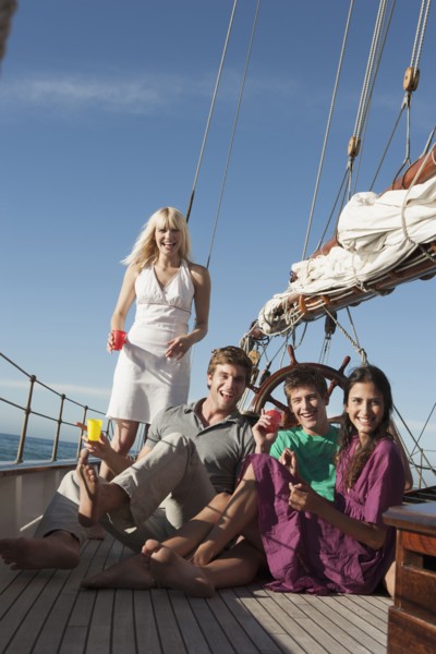Caucasian friends relaxing on sailboat