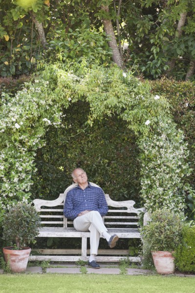 Senior Caucasian man sitting on garden bench