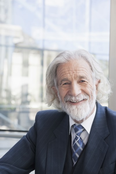 Senior Caucasian businessman smiling in office