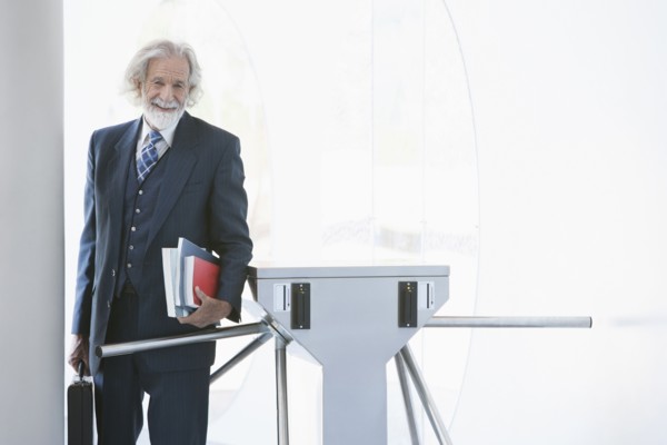 Senior Caucasian businessman carrying books