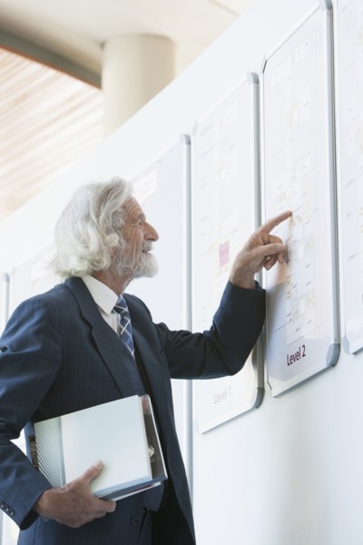 Senior Caucasian businessman reading directory