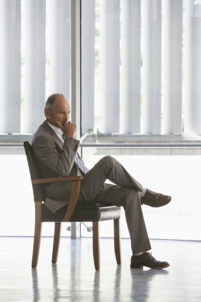 Senior Caucasian businessman sitting in chair