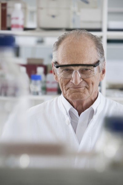 Senior Caucasian scientist smiling in lab