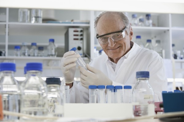 Senior Caucasian scientist examining samples in lab