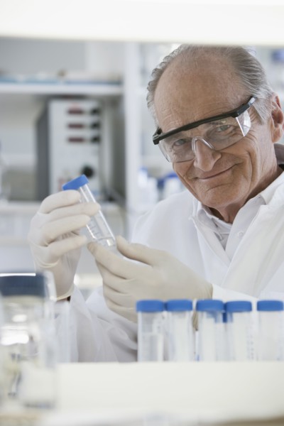 Senior Caucasian scientist examining samples in lab
