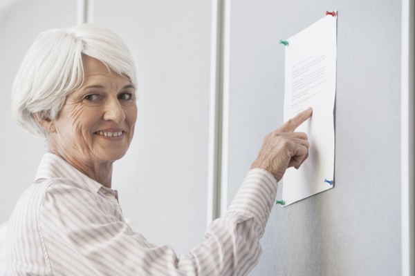 Senior Caucasian woman reading sign