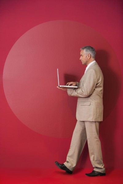 Businessman walking with laptop