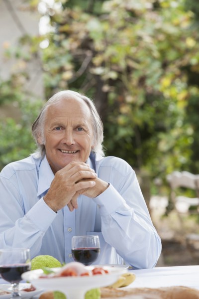 Man eating at table outdoors