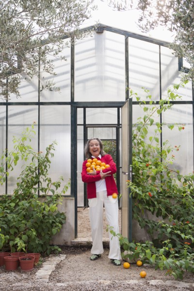 Woman harvesting fruit in greenhouse