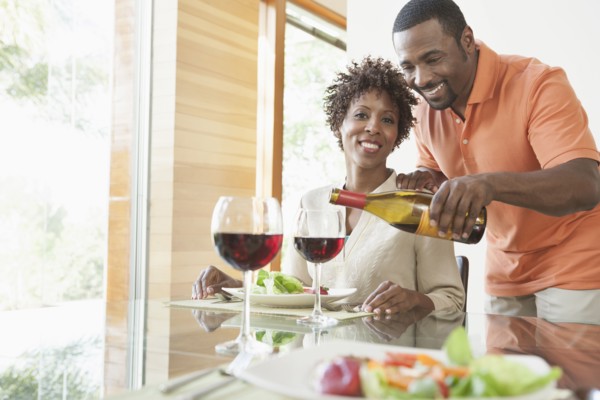 African American couple having wine at dinner